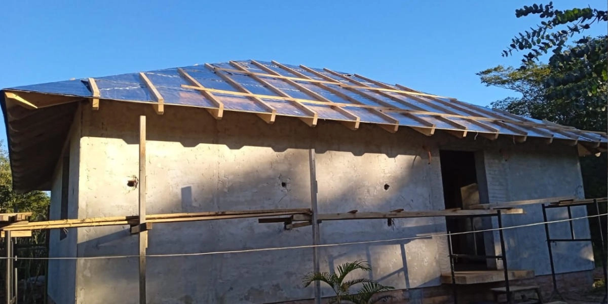 Einstöckiges Haus im Bau in Paraguay mit hölzerner Dachkonstruktion und Betonwänden, zeigt ein Wohnbauprojekt