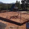 Excavación manual de cimientos en Paraguay con acero de refuerzo atado a mano y encofrado para la losa de una casa unifamiliar